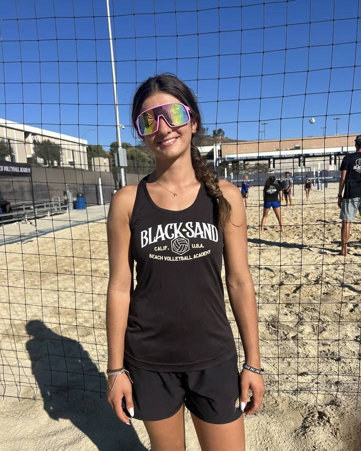 Coach Natalia Galstian at the net in a Black Sand tank