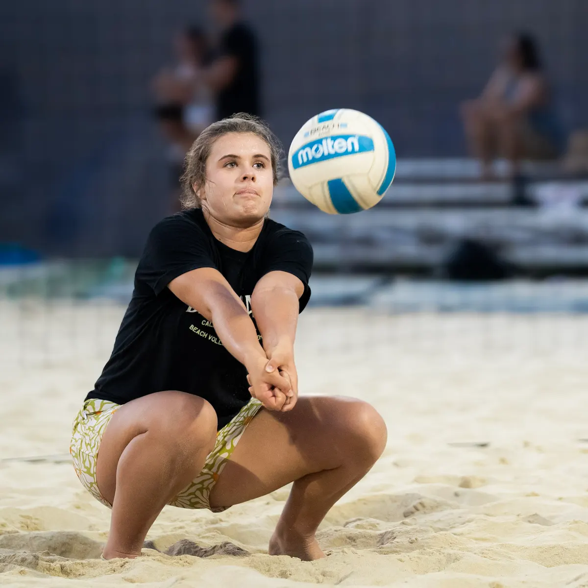 A Black Sand player settles under the ball to pass under the court lights