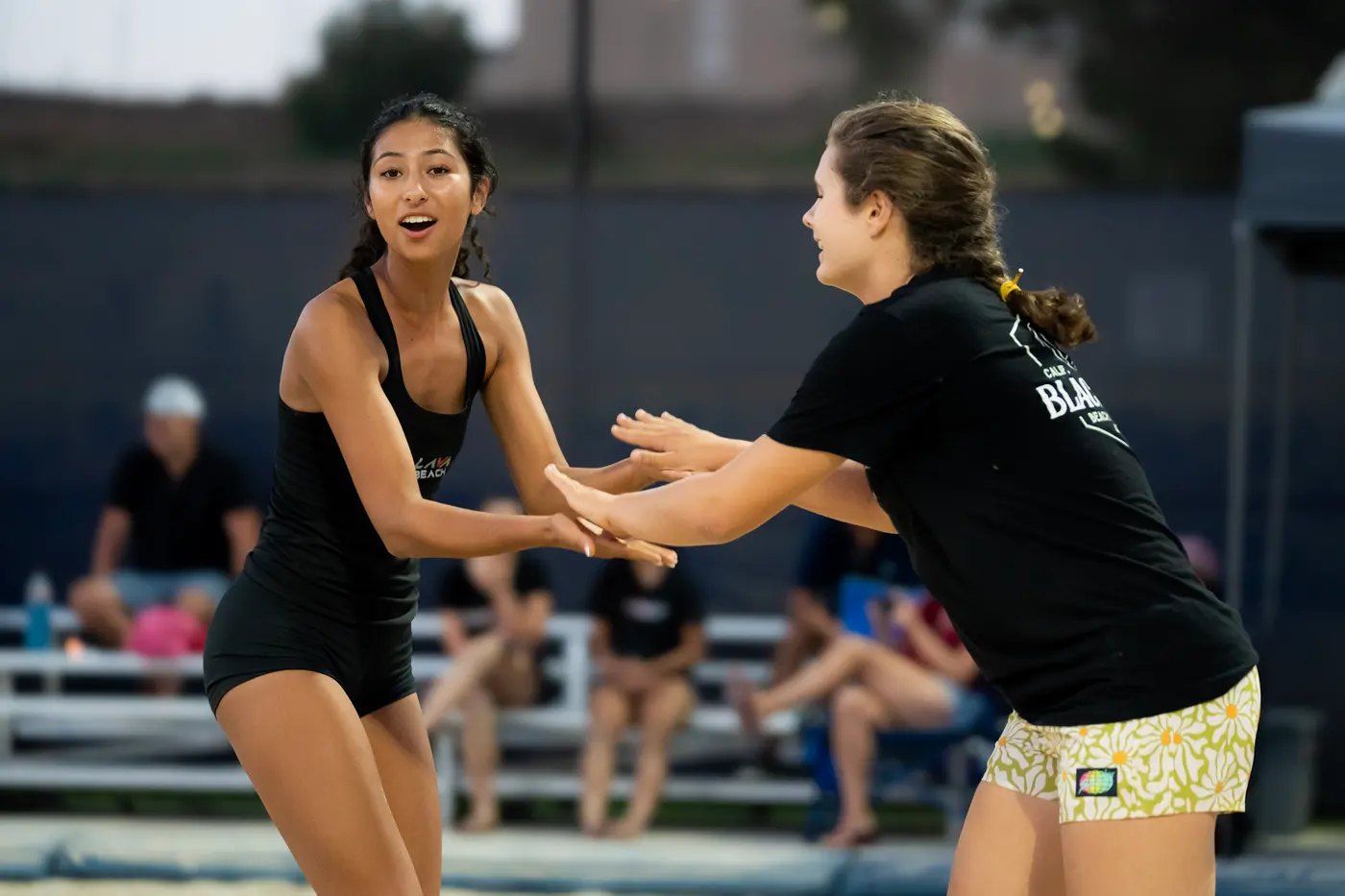 Two Black Sand players celebrate a point