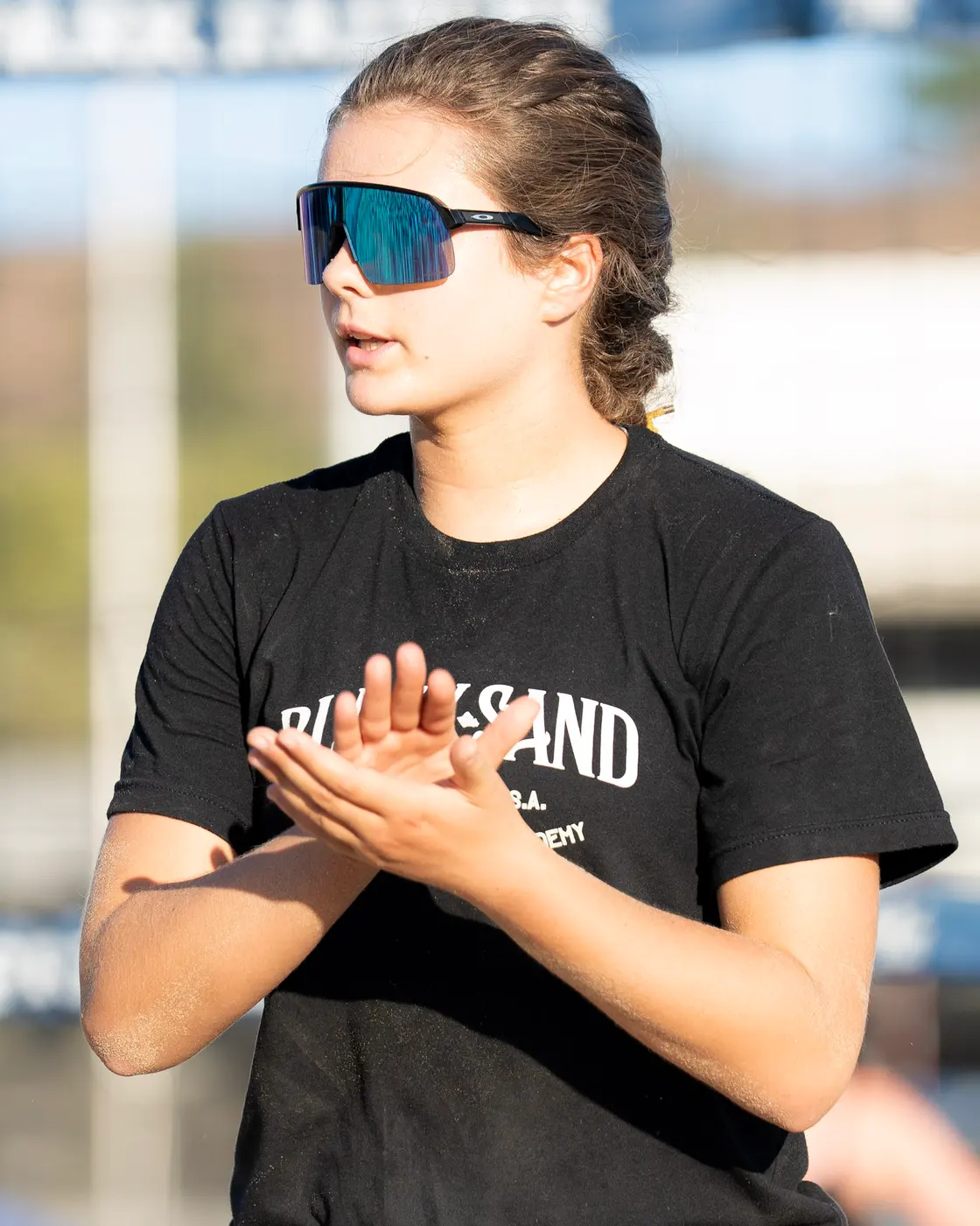 A Black Sand player claps between points