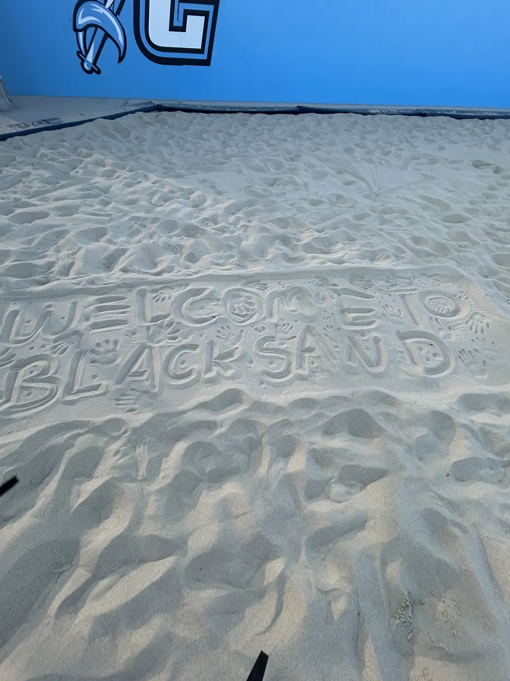 Welcome to Black Sand written in the sand