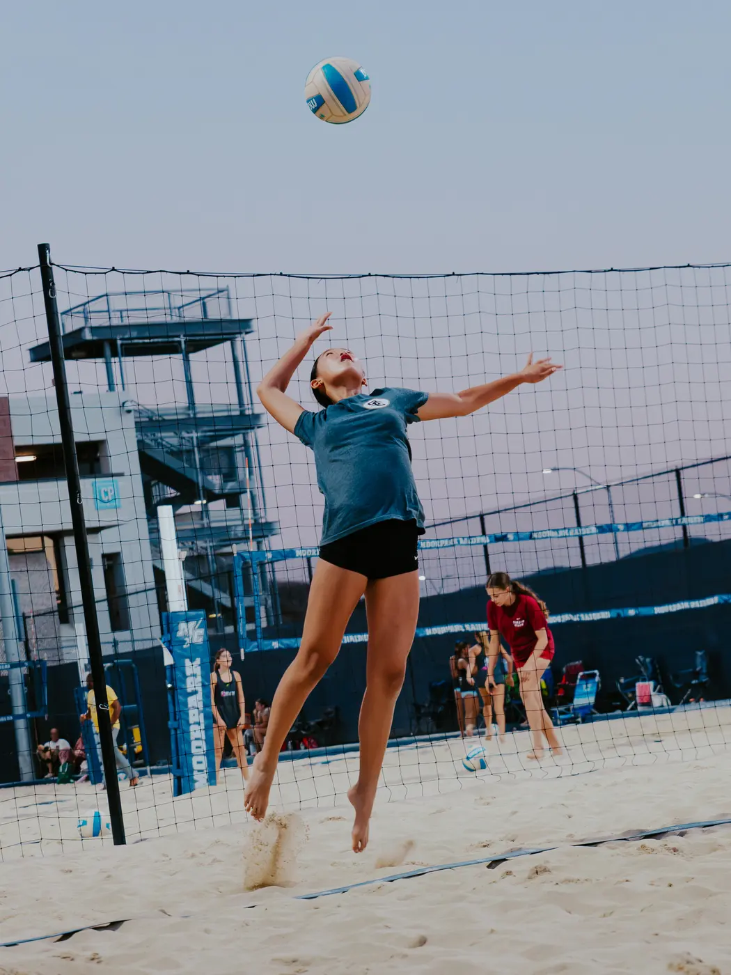 A player rises to attack at the net